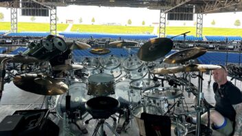 Bob Strakele preparing drum kit for live performance with Austrian Audio mics.