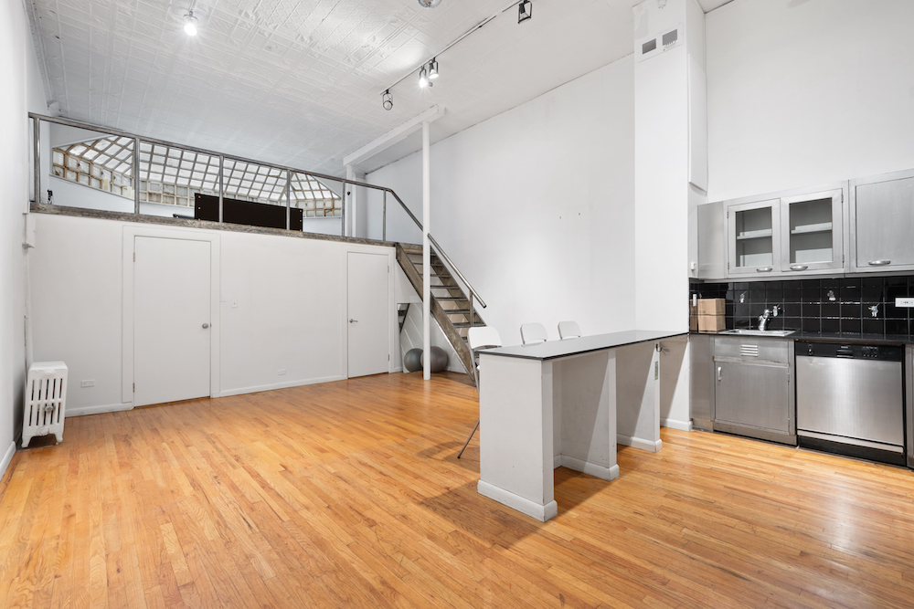 The first-floor open kitchen and upper loft. Photo: Courtesy of JLL.