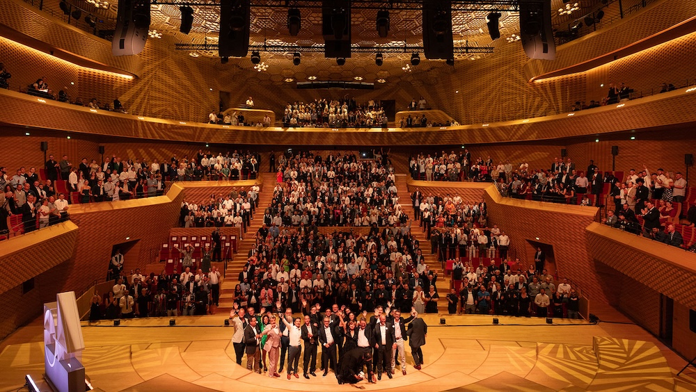 The entire L-Acoustics team celebrating the company’s 40th anniversary at Paris’ La Seine Musicale